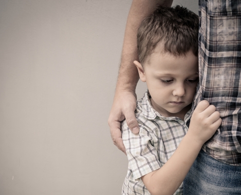 young boy hugging dad