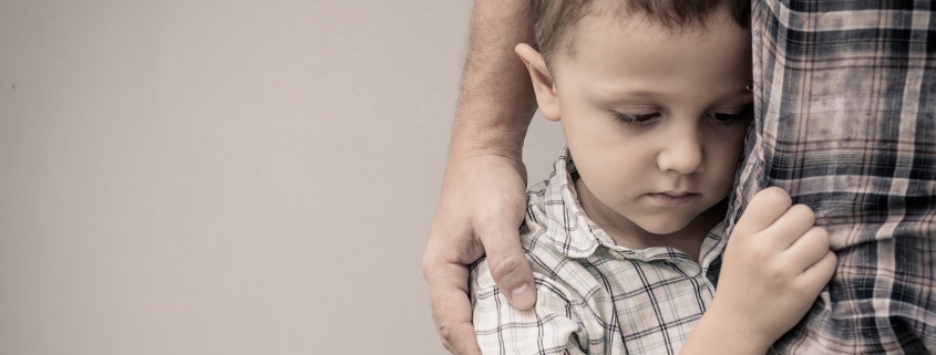young boy hugging dad